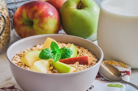 Sweet delicious healthy breakfast. Porridge with apples on the kitchen table.の写真素材