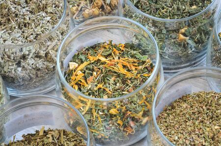 Set of various herbs. Herbal teas in jars on a wooden table.の写真素材