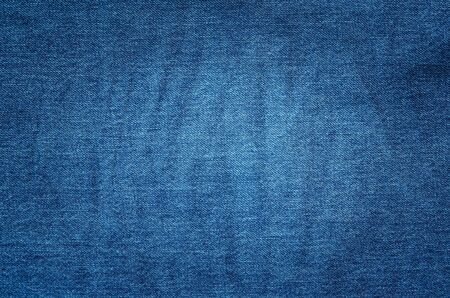 Dark fabric background. Dark blue jeans texture.の写真素材