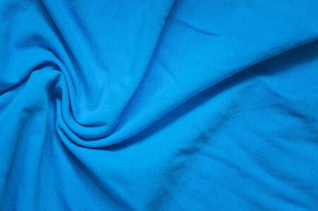 Interesting conceptual background with clothes. Texture of blue wrinkled material.の写真素材