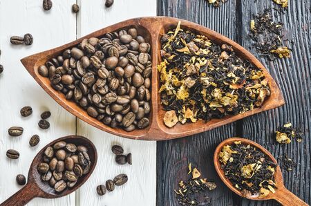 Coffee versus tea. Interesting concept with coffee and tea on black and white wood.の写真素材