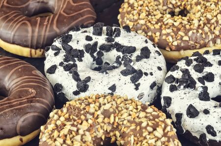Sweet colorful dessert. Donut with a hole and colorfuls delicious icing.の写真素材