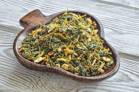 Herbal tea in the kitchen. Colorful tea in a wooden dish.の写真素材