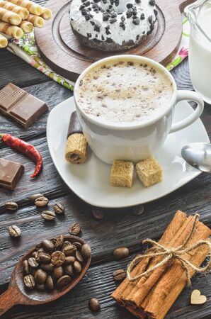 Elegant concept of serving coffee in vintage style. Coffee with foam and cinnamon with various sweets and decoration.の写真素材