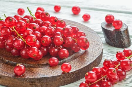 Red fruit in the kitchen. Red currant on a white wooden table.の写真素材
