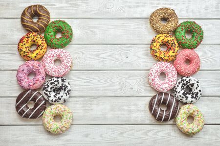 Colorful sweet cakes. Donuts with a hole with different toppings and decorations.の写真素材