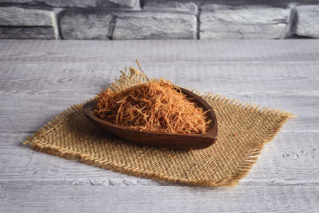 Good herbs for immunity. Cat's claw on a wooden bowl.の写真素材