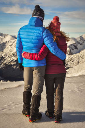 Great winter mountain adventure. Couple in love on top of a mountain in the Polish Tatras.の写真素材