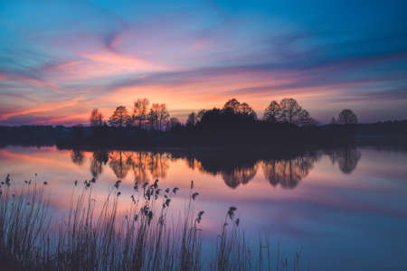 Beautiful colorful morning landscape. Wonderful sky over a Polish lake.の写真素材