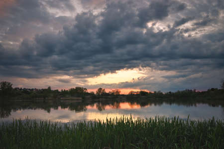 Beautiful colorful spring landscape. Morning with a beautiful sky by the lake.の写真素材