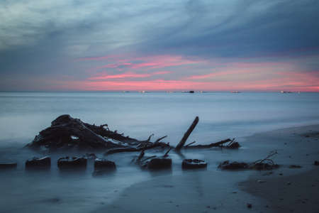 Wonderful colorful seaside landscape. Wooden beams against the background of the blurred sea.の写真素材