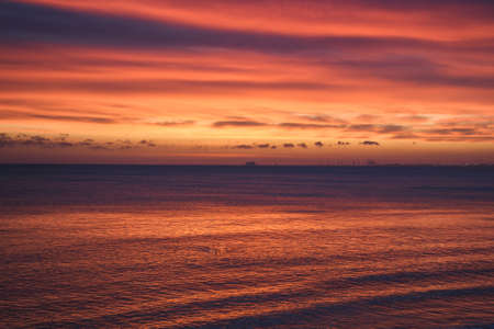 Abstract colorful sea background. Sea waves and beautiful colorful sky at sunrise.の写真素材