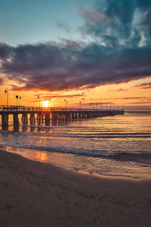Colorful seaside morning landscape. Wooden pier on the sea at sunrise.の写真素材
