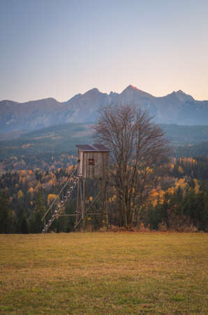 Autumn mountain landscape in the countryside. View with a charming wooden hut in the village of Lapszanka, Poland.の写真素材