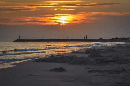 Beautiful sunrise over the sea. Summer morning on the beach in Leba, Poland.の写真素材
