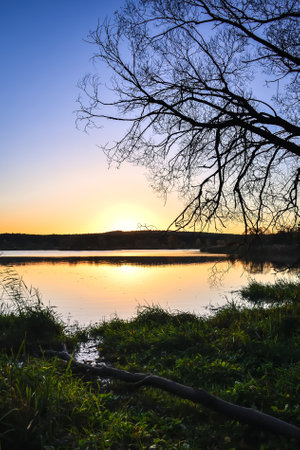 Beautiful autumn landscape. The rising sun in the morning by the lake.の写真素材
