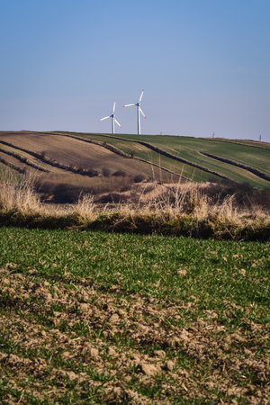Renewable energy sources. Ecological windmills in the countryside in Poland.