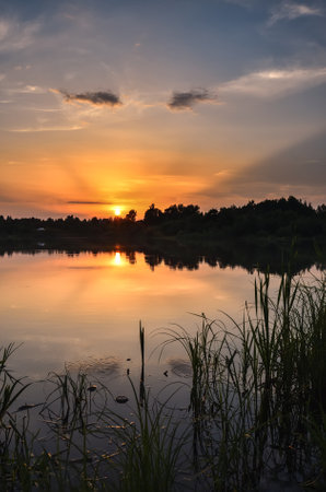 Wonderful, colorful summer landscape. Sunset in the beautiful sky over the lake.の素材 [FY310193733508]