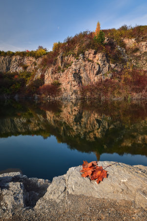 Natural conceptual autumn idea. Quarry landscape with leaves in fall colors.の写真素材