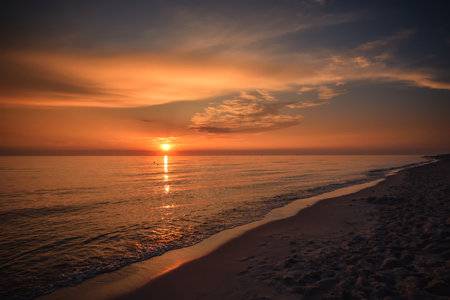 Beautiful summer holiday landscape. Sunset over the Polish sea in Leba.の写真素材