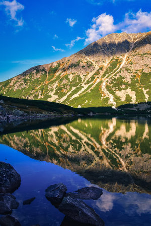 Beautiful mountain lake in summer scenery. Black Gasienicowy Pond in the Polish Tatra Mountains.の写真素材