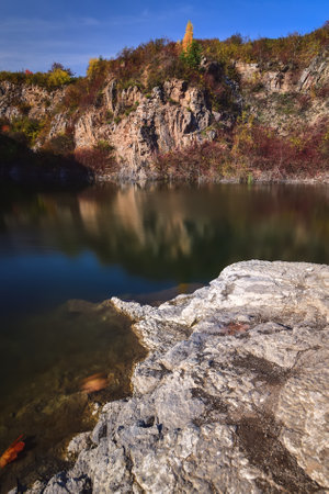 Natural conceptual autumn idea. Quarry landscape with leaves in fall colors. Photo taken in Kielce, Poland.の写真素材