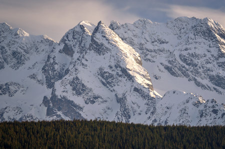 Beautiful evening view of the snow-capped mountains. View of the mountain peaks from the Wielki Kopieniec peak in the Polish Tatra Mountains.の写真素材