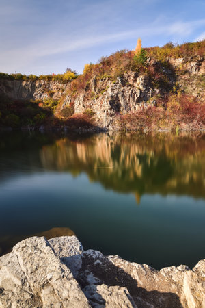 Natural conceptual autumn idea. Quarry landscape with leaves in fall colors. Photo taken in Kielce, Poland.の写真素材