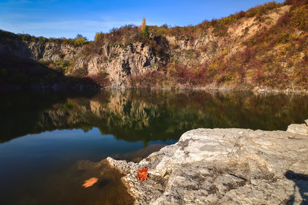Natural conceptual autumn idea. Quarry landscape with leaves in fall colors. Photo taken in Kielce, Poland.の写真素材