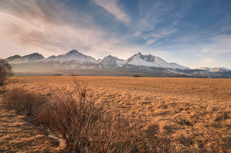 Beautiful, mountainous, spring panorama. White snow-covered peak in the Slovak Tatra Mountains. Photo taken in the village of Nova Lesna, Slovakia.の写真素材