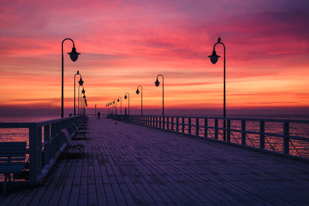Beautiful sunrise over the Polish sea. Popular pier on the Baltic Sea at sunrise. Photo taken in Gdynia, Poland.の写真素材