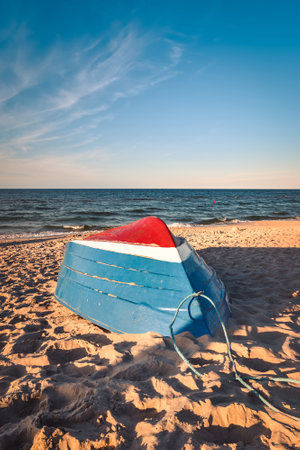 Beautiful colorful theme to welcome the holidays. Colorful boat on the beach by the blue sea. Photo taken in Jastarnia, Poland.の写真素材