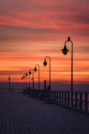 Beautiful sunrise over the Polish sea. Popular pier on the Baltic Sea at sunrise. Photo taken in Gdynia, Poland.の写真素材