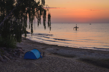 Beautiful morning seaside landscape. Tent on the beach in Gdynia, Poland.の写真素材