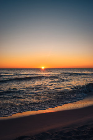 Beautiful colorful landscape on the beach by the sea. Sunrise over the Baltic Sea in Jastarnia, Poland.の写真素材