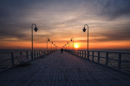 Beautiful sunrise over the Polish sea. Popular pier on the Baltic Sea at sunrise. Photo taken in Gdynia, Poland.の写真素材
