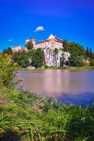 Beautiful historic monastery on the Vistula River in Poland. Benedictine abbey in Tyniec near Krakow, Poland. Long exposure photo with blurred water effect.の写真素材