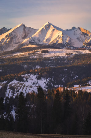 Charming panorama of the Polish Tatra Mountains in the morning. View of the Belianske Tatras from the village of Lapszanka, Poland.の写真素材