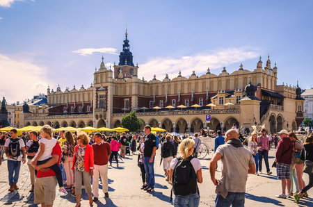 Krakow, Poland - August 16, 2014: Tourists visiting the main market square in Krakow (Poland), which is one of the most famous and beautiful in Europe. Cloth Hall (Sukiennice) in Krakow.のeditorial素材