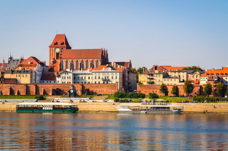 Torun, Poland - September 17, 2014: Panorama of Torun, old medieval town in Poland. Tourist boats on...