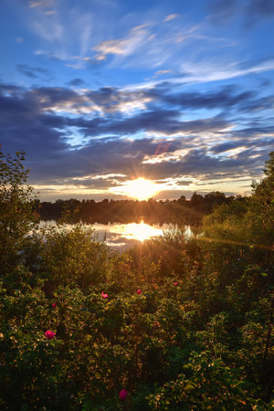 Beautiful colorful landscape by the lake in the countryside. Sunset on the Mojcza lake near Kielce, Poland.の写真素材