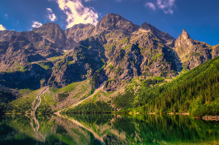 Beautiful clean lake in the Polish mountains in a summer, sunny scenery. Popular Polish Lake Marine Eye in High Tatra Mountains, Poland.の写真素材