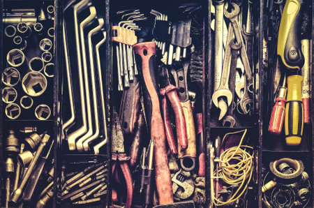 Workshop tools in a black metal box.. Toolset with interior compartments to keep wrenches, ring spanners, hammer, pliers, screwdrivers, monkey wrenches, screws, bolts, wire and other (DIY) tools.の写真素材