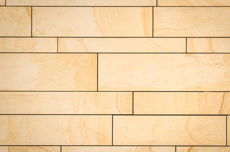 Building wall made of ceramic tiles. Beige tiles wall background or texture.の写真素材
