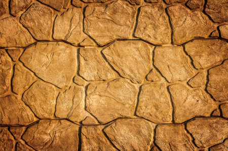 Old bright stone texture. Beige wall background of stone tiles.の写真素材