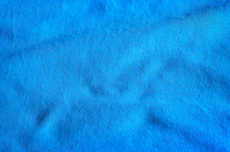 Blue wavy fabric texture. Close-up of cotton t-shirt, may be used as background.の写真素材