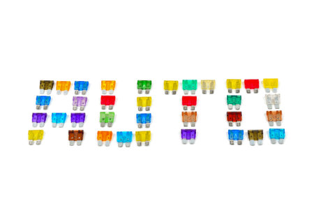 Inscription AUTO made of car fuse. Pile of colorful electrical automotive fuses or circuit breakers, shaped into a word AUTO, isolated on white background.の写真素材