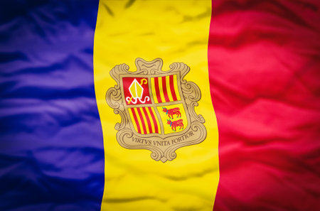 Andorra flag on a fabric wavy background. Wavy flag of Andorra fills the frame.の写真素材