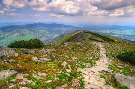 Mountain landscape in spring season. Picturesque view stretches of the highest peak in Beskids mountains (Babia Gora) over trail running the ridge, Poland.の写真素材
