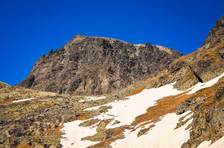 Early spring mountain landscape. Picturesque view stretches over high rocky summit in valley of the Five Spis Ponds in Tatra mountains, Slovakia.の写真素材